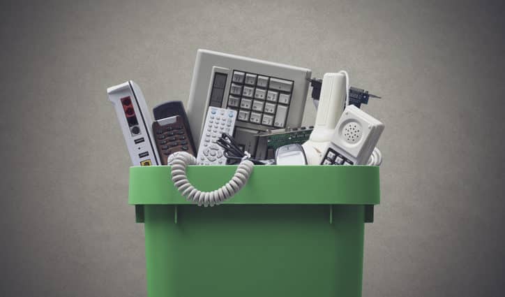 Waste bin full of electronics, e-waste and recycling concept
