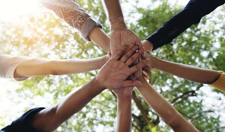 Diverse multiethnic Partners hands together teamwork group of multiracial people meeting join hands togetherness. Diversity people hands join empower partnership teams connection volunteer community